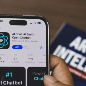 Hand holding a smartphone with AI chatbot app, emphasizing artificial intelligence and technology.